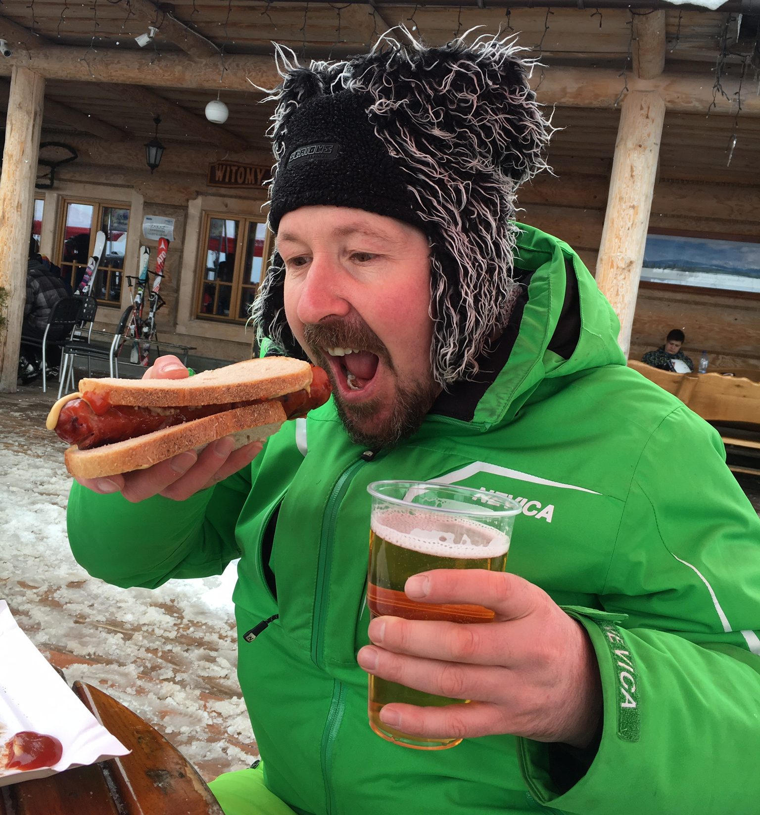 Skier with beer and hot dog